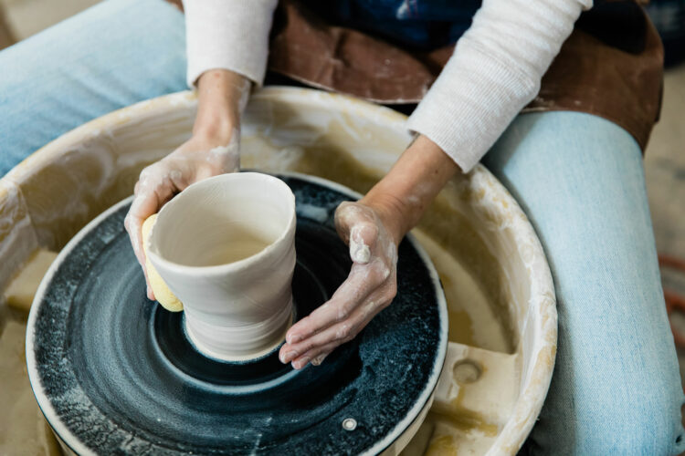 Pottery bowl being formed from clay on a wheel