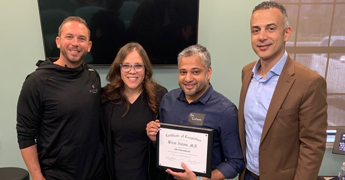 Dr. Bilal Islam holding certificate of completion with his two team members and a Sonex Health consultant.