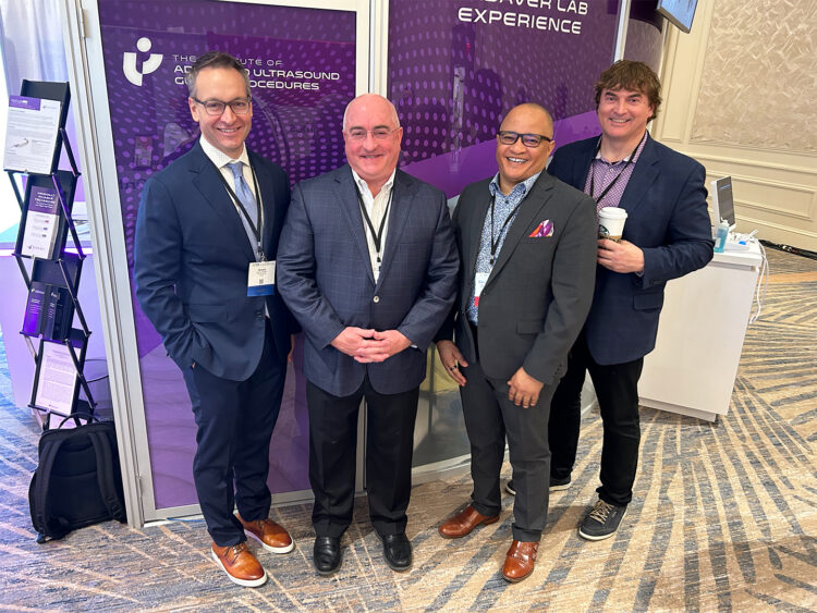 Hand surgeon next to the CEO and two Founders of Sonex Health medical device company in front of a conference booth. 