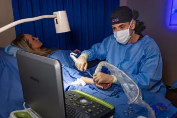 Dr. Grabow performing carpal tunnel release with ultrasound guidance on patient